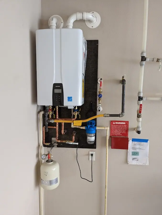 Professional plumber installing copper piping in a Monett home